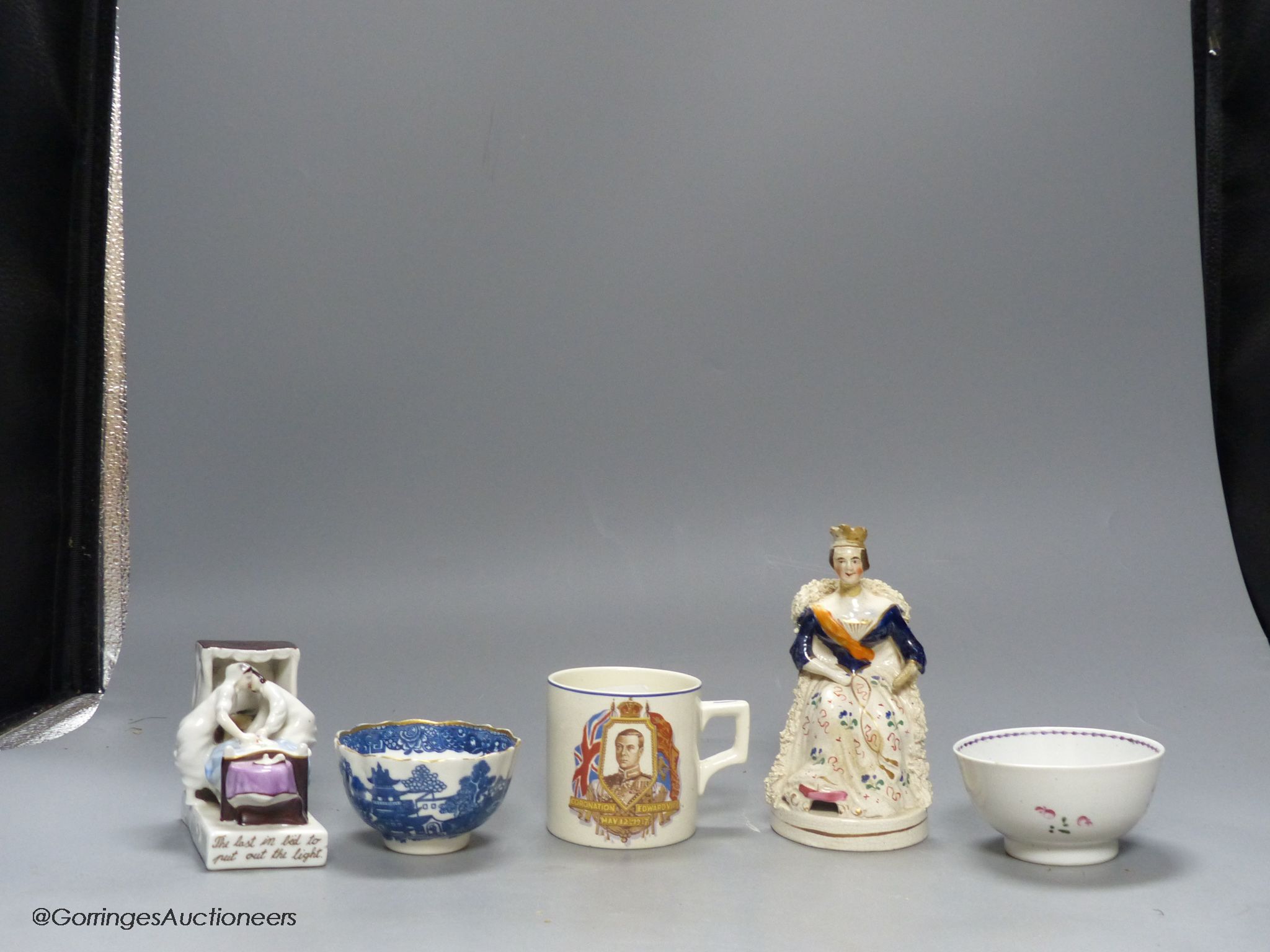 A German porcelain fairing - ' Last in bed', a famille rose tea bowl and three other pieces